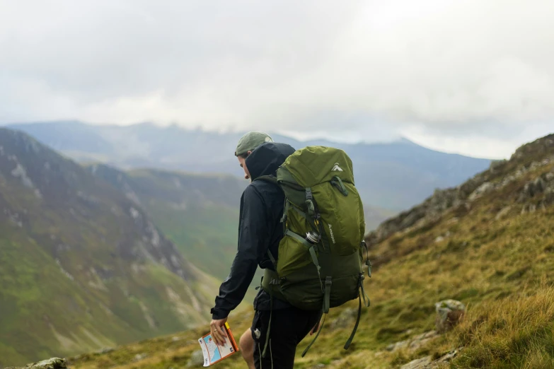 a man walking up the side of a mountain