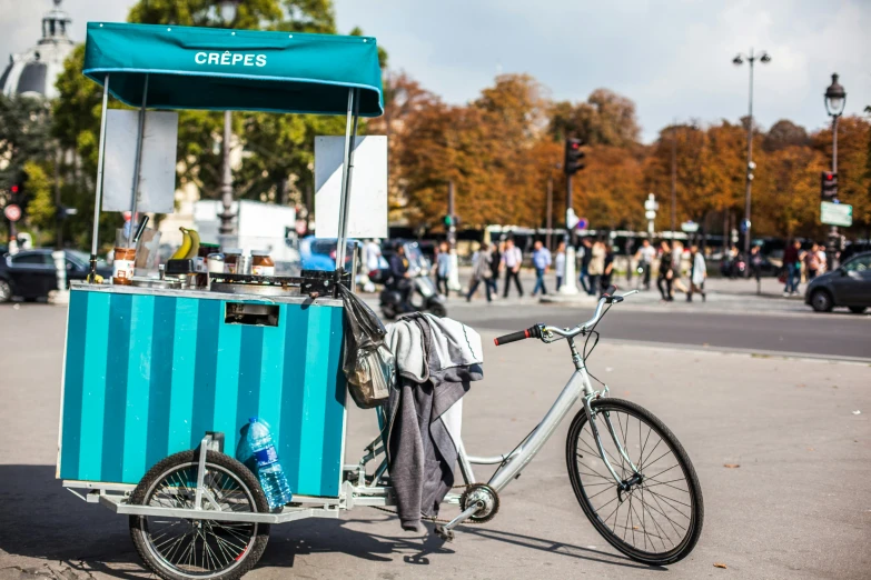 a bike is parked next to a food cart