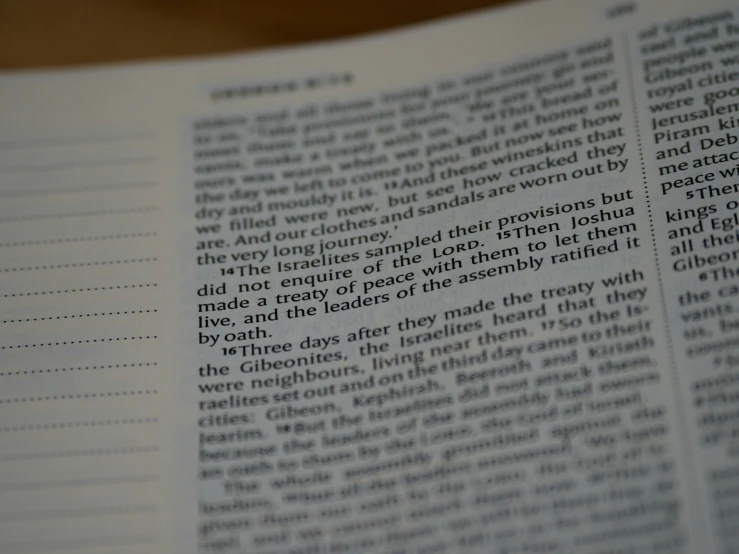 a large book with white text on a wooden table