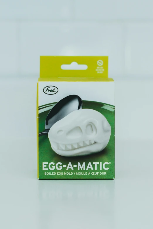 a white egg - a - matic holder with a face