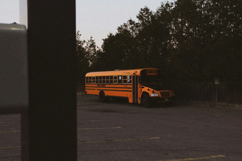 an empty bus is parked next to trees