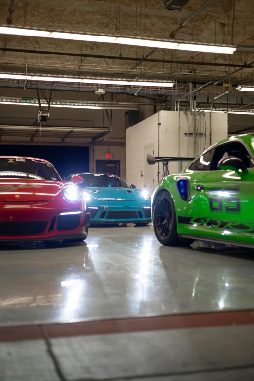 some pretty colorful cars parked inside a garage