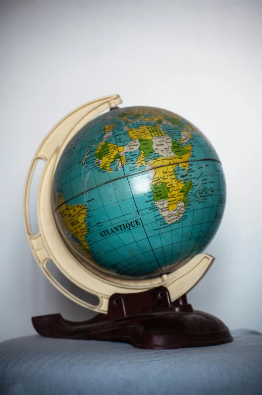 a blue and gold globe with white lines and lines around the center