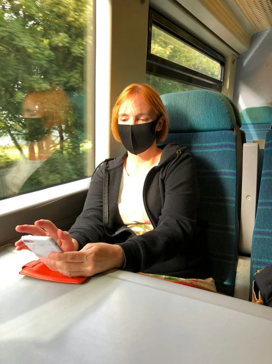 there is a person that is wearing a mask on the train