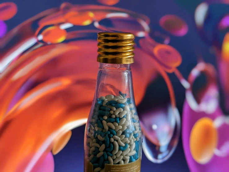 a bottle with blue and gold sprinkles in it