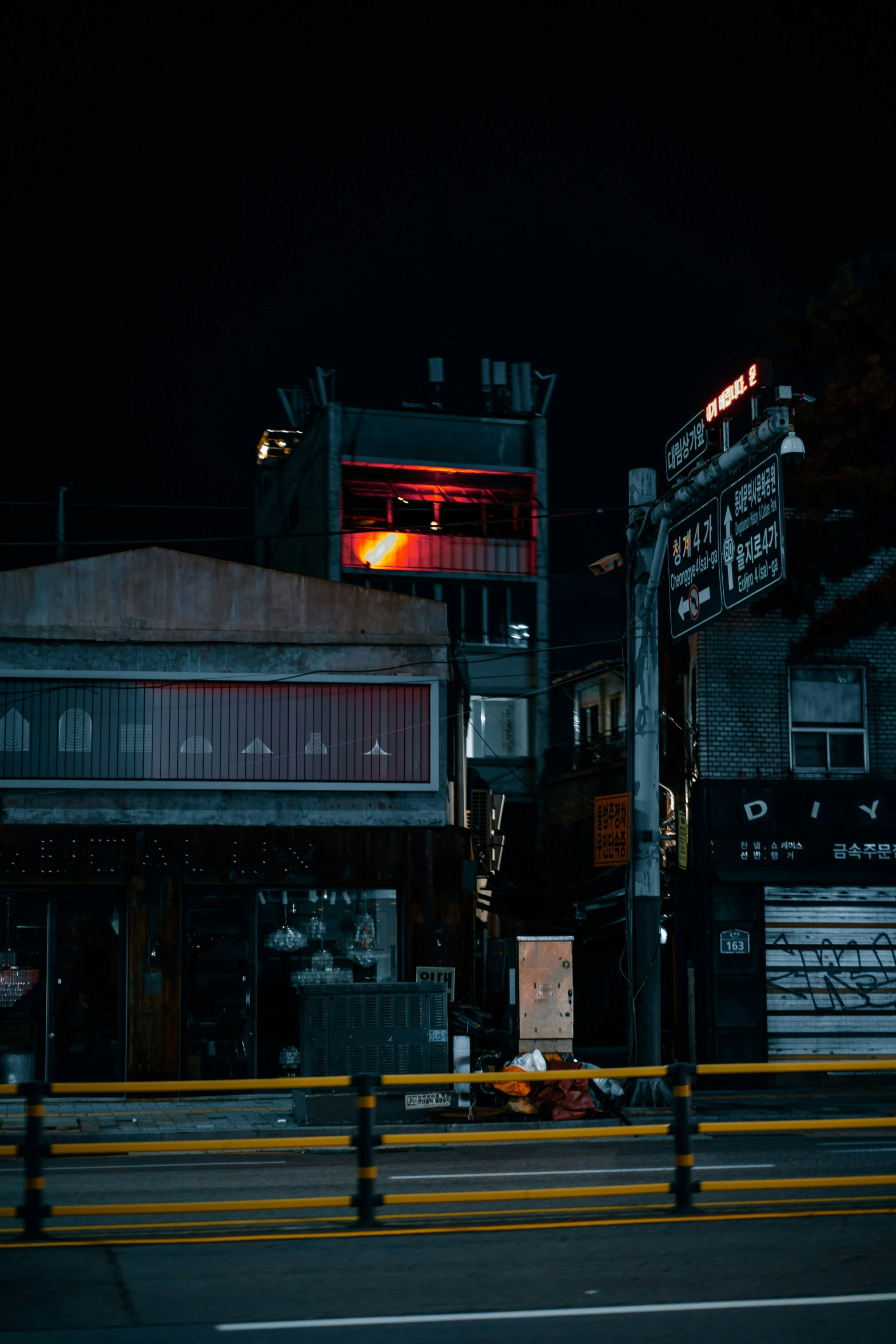 some red lights are in front of a building and a stop light