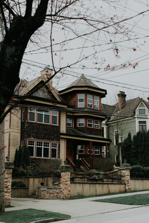 two very big beautiful homes with many windows