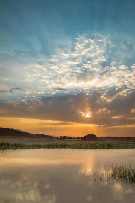 the sun is setting in the sky over the water