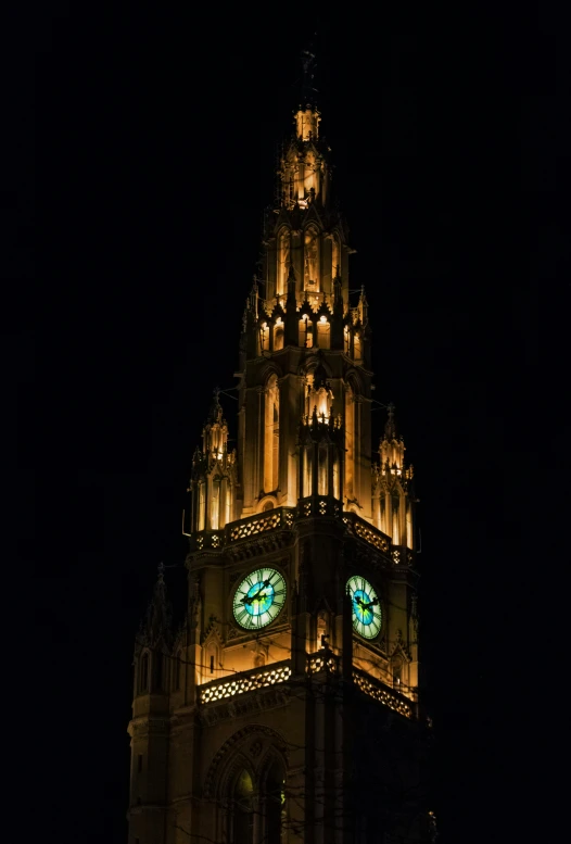 large cathedral with many clocks lit up at night