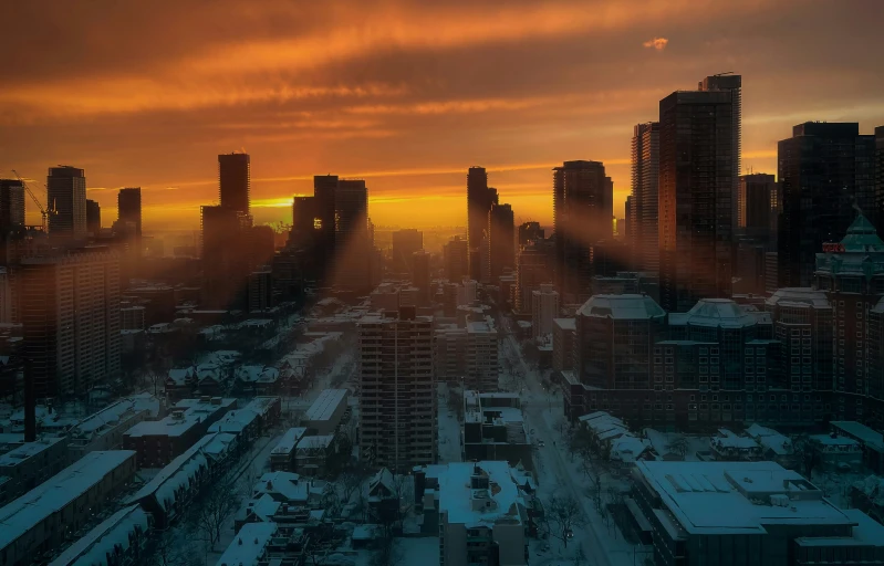 the sun is setting on a city in winter