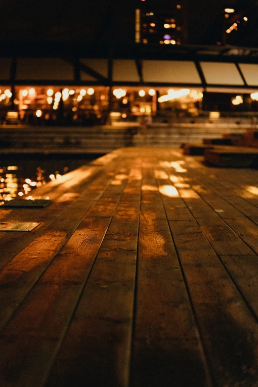 a view of some water next to a building at night