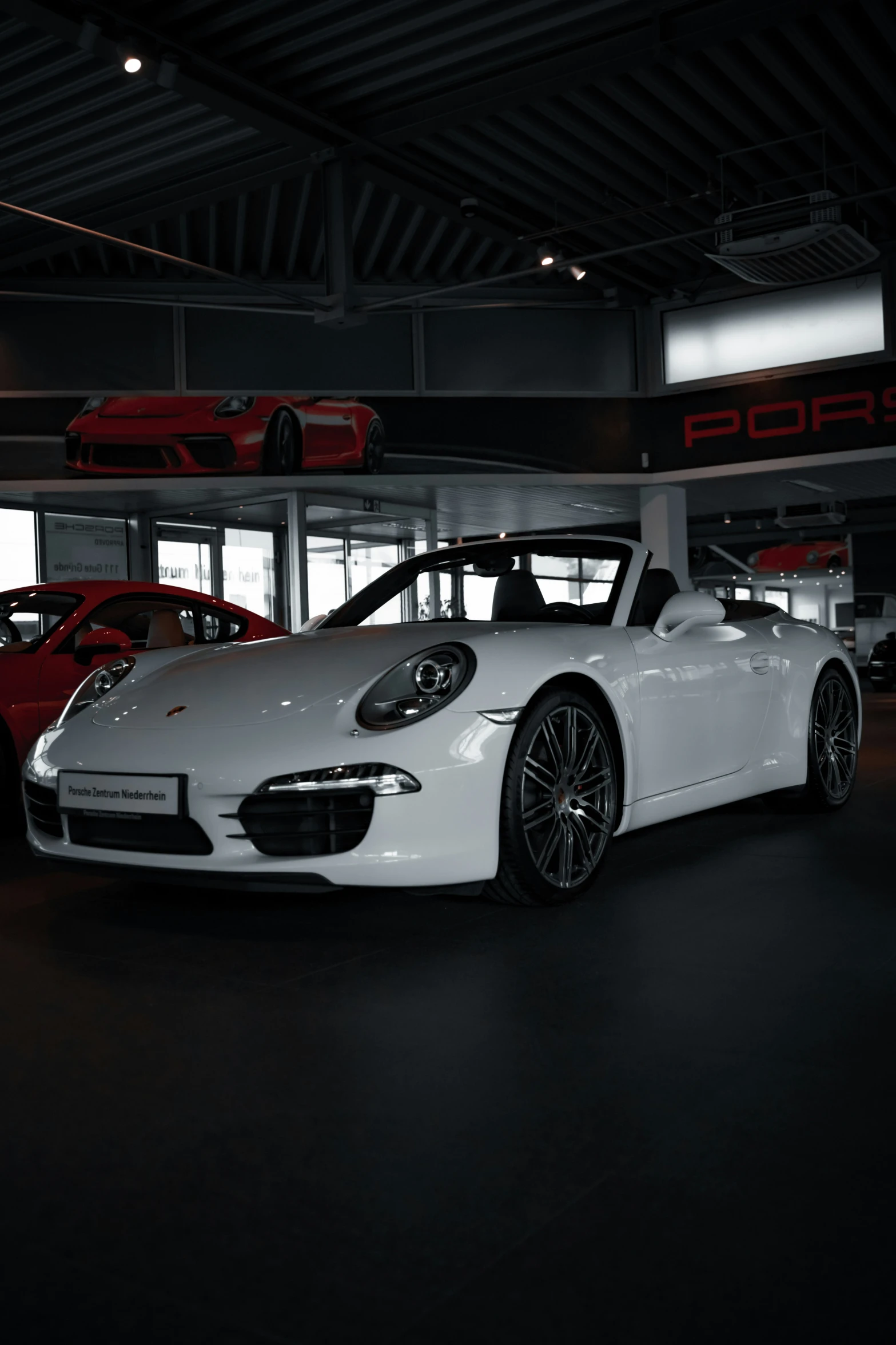 the porsche sports car displayed in a show room