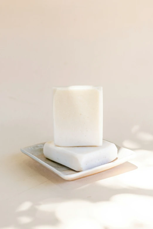 two cubes of soap sitting on a plate