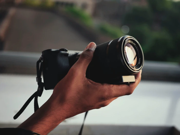 a pographer holding his camera up for a po