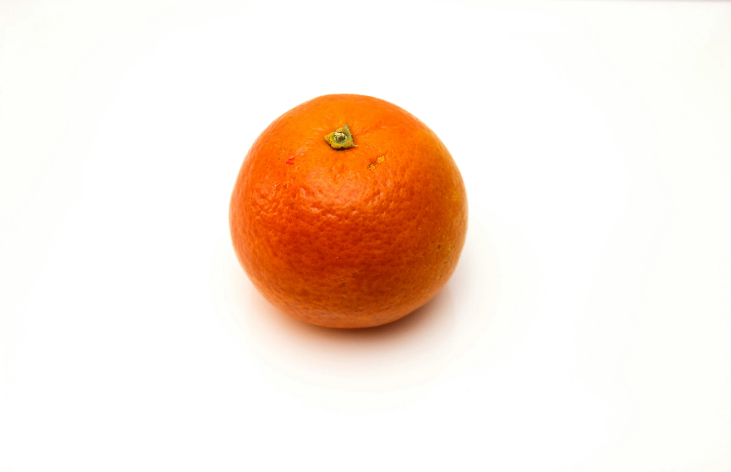 an orange sitting on top of a white counter