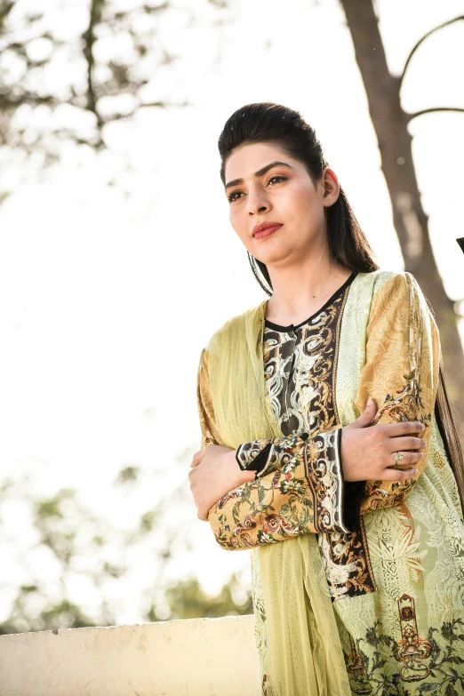 woman in an intricate ethnic outfit standing outside