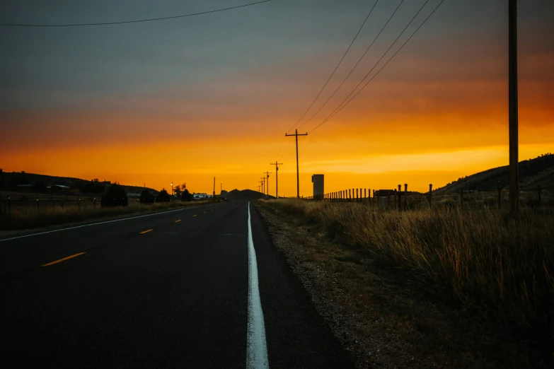 there is a street sign in front of a yellow sky