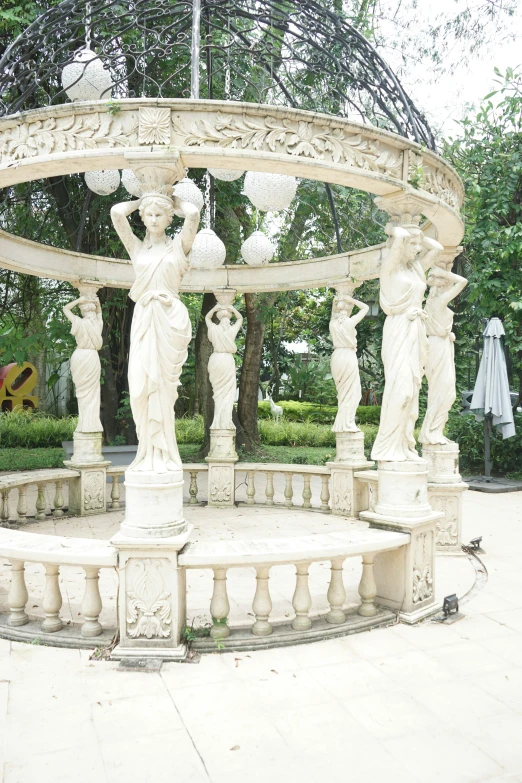 a white marble fountain and sculpture in a park