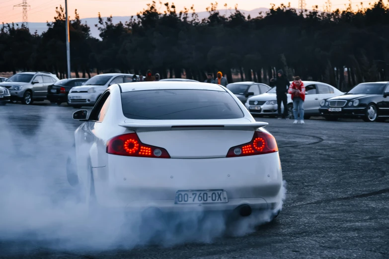 a white car that is parked in the street