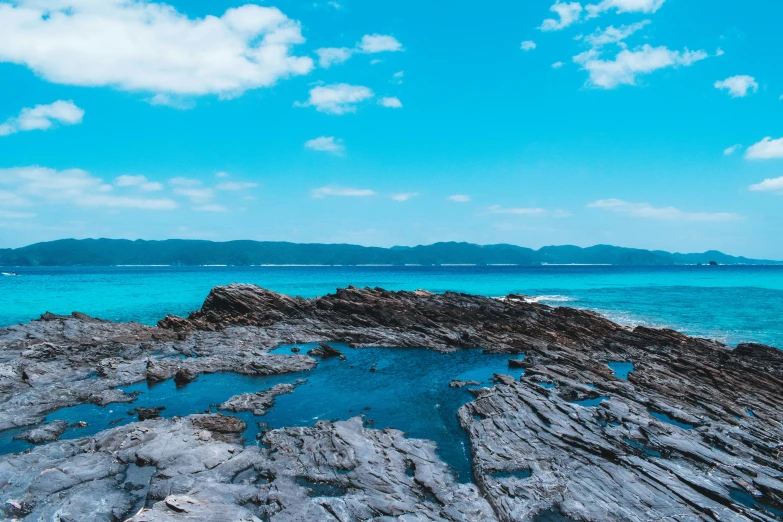 large rocky outcropping on an island near the ocean