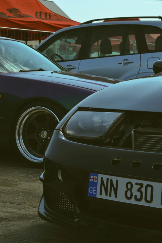 the front grille of a parked car next to another car