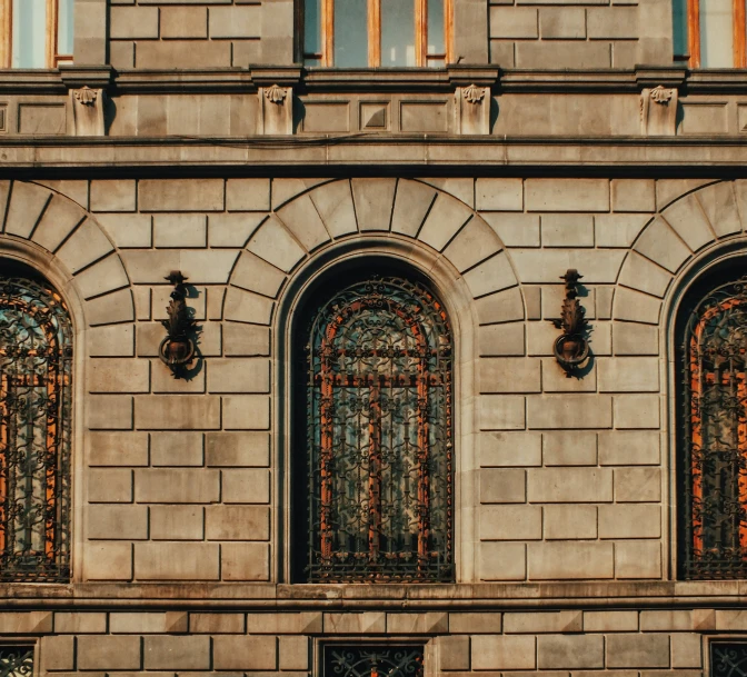 a group of windows on a building by the street