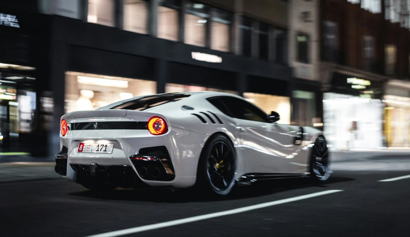 a sports car parked on the side of a city street