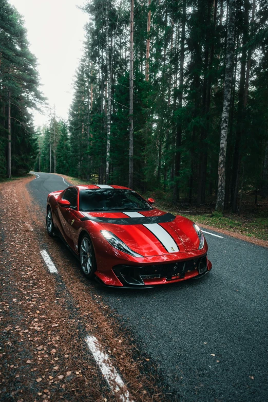 a car driving on a road in the woods