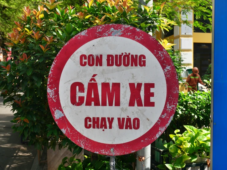 a red and white sign saying that the language can be found in different languages