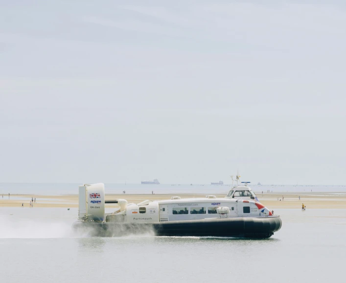 an inflatable boat sitting on the beach in the water