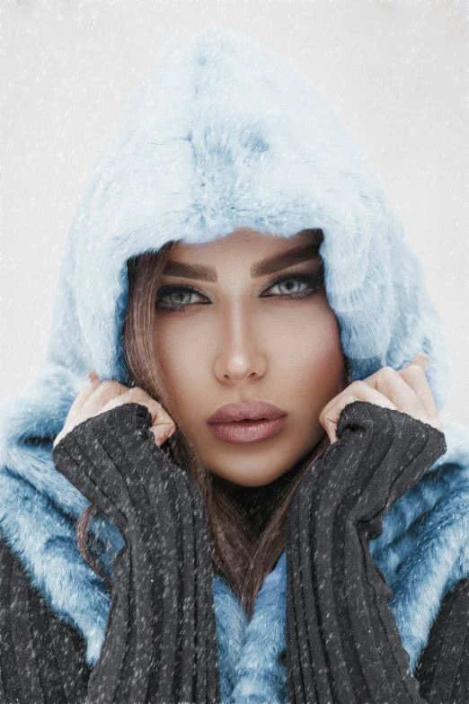 a woman in a hat and jacket standing in the snow