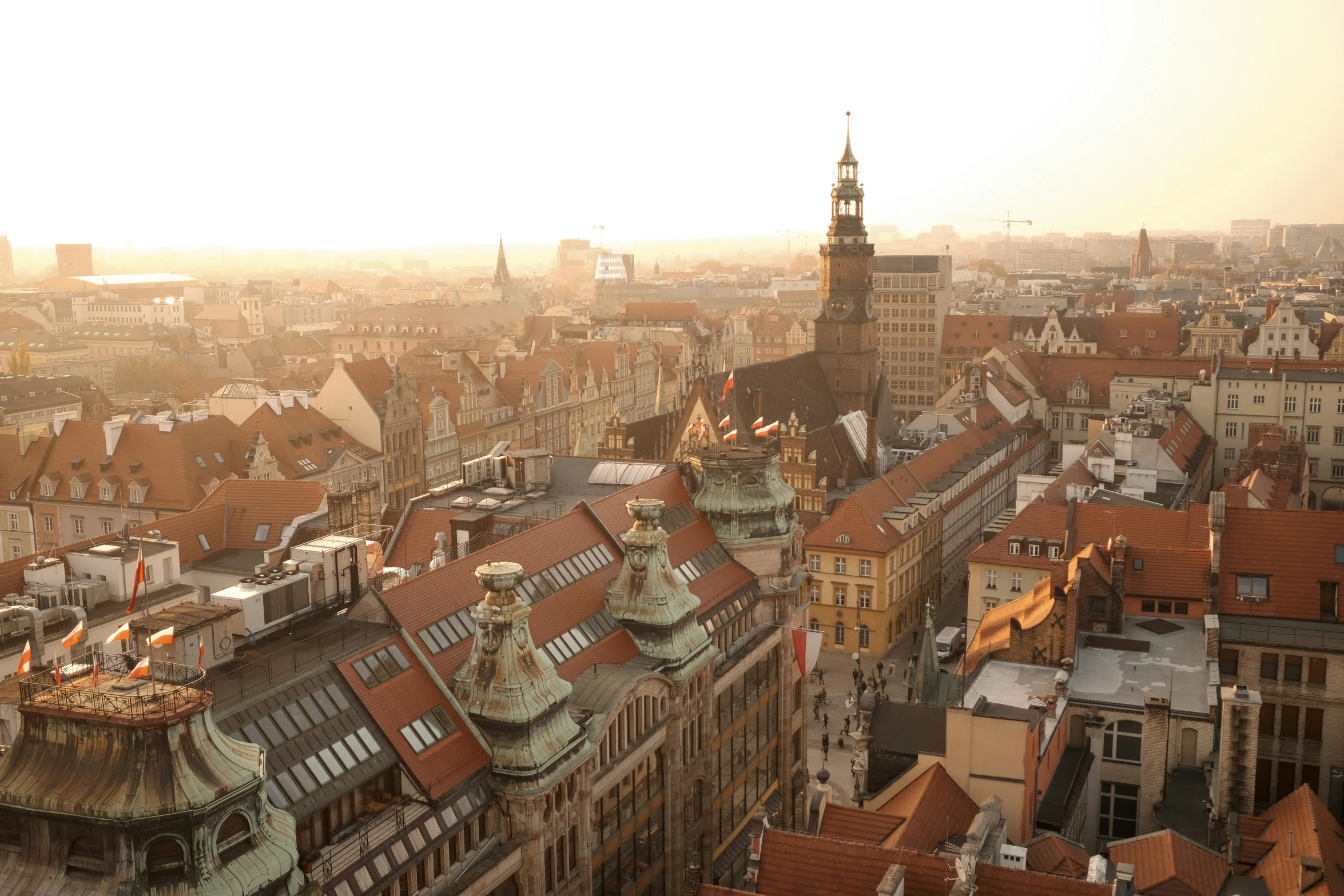 a city with a very tall clock tower next to other buildings