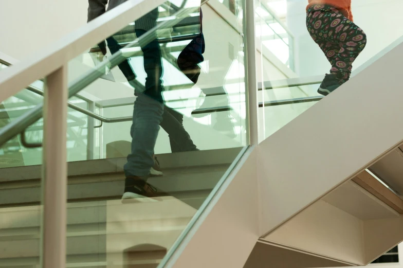 two people walking up an escalator together