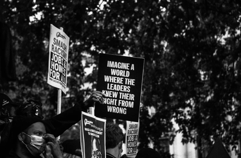 there are many people holding up signs in a group