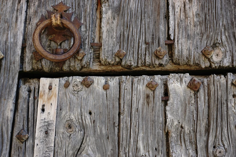 a door is broken with a rusty latch