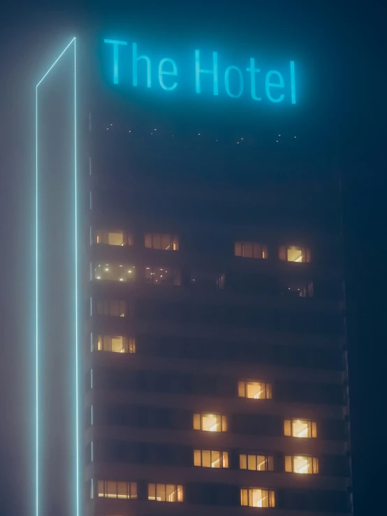 a tall building sitting under a blue sign in the sky