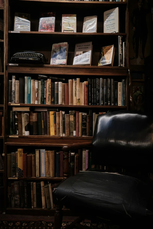 a bookshelf filled with lots of book in a dimly lit room
