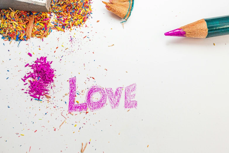 colorful crayons and pencils written in spanish love