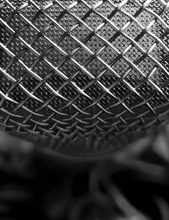 a metallic colored microphone with a blurry background