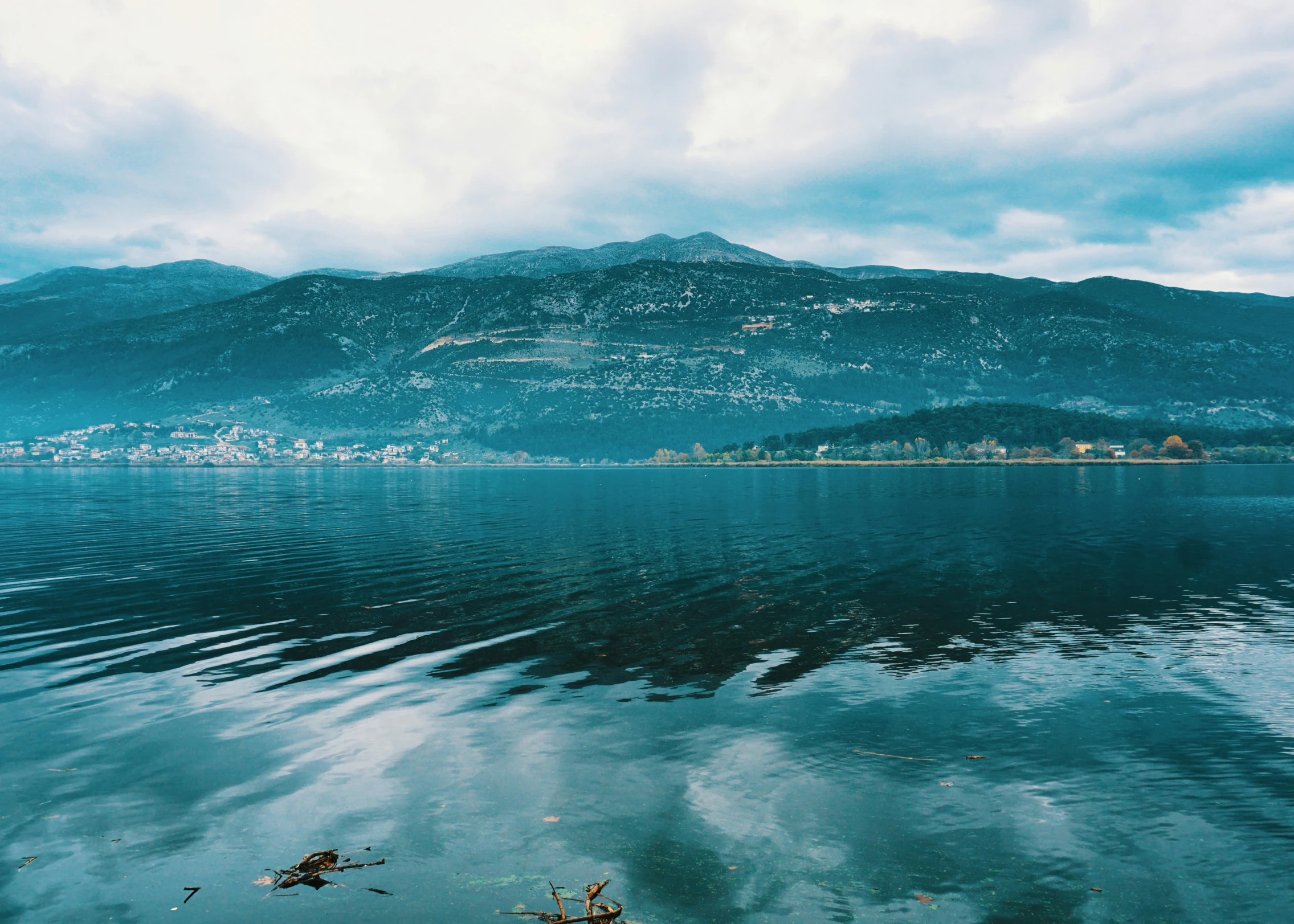 an artistic po of a lake with mountains and trees