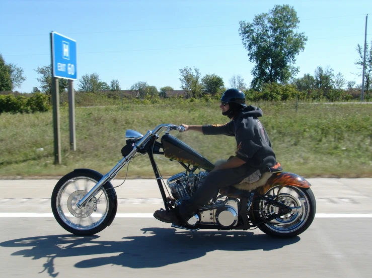 a guy is riding a motorcycle down the street