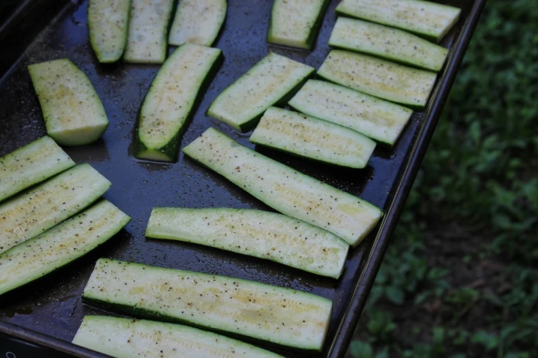 a pile of sliced up cucumber sitting on a grill