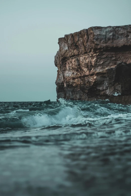 water that is next to some rocks in the ocean