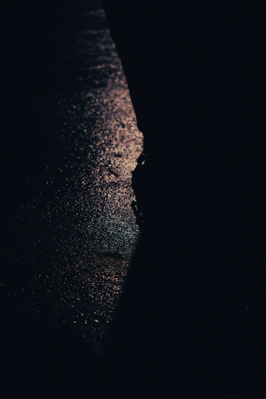 a person on a surfboard riding at night