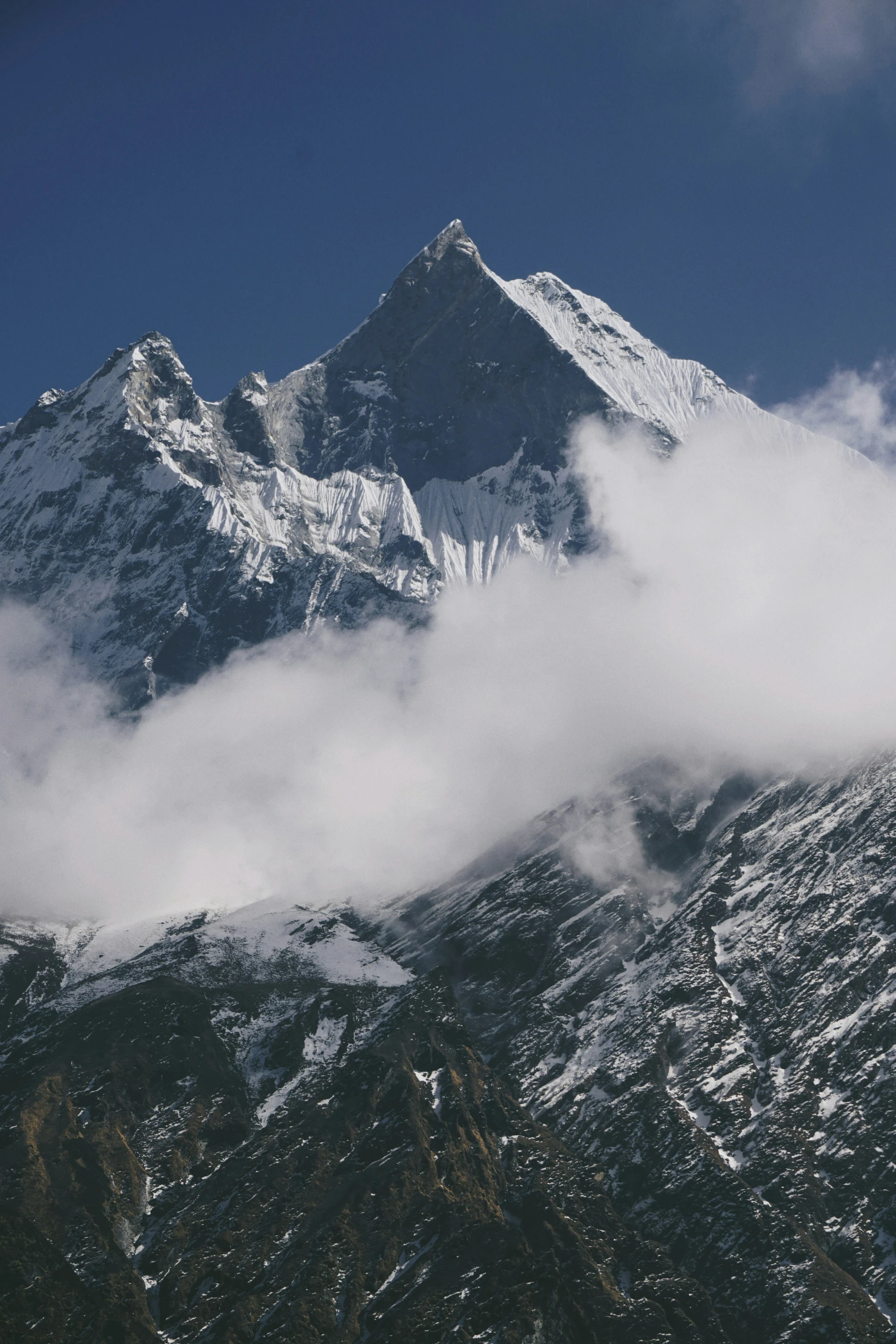 an airplane is flying high above the mountains