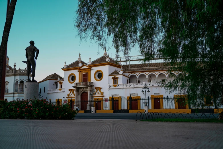 a large white building with a statue in front of it