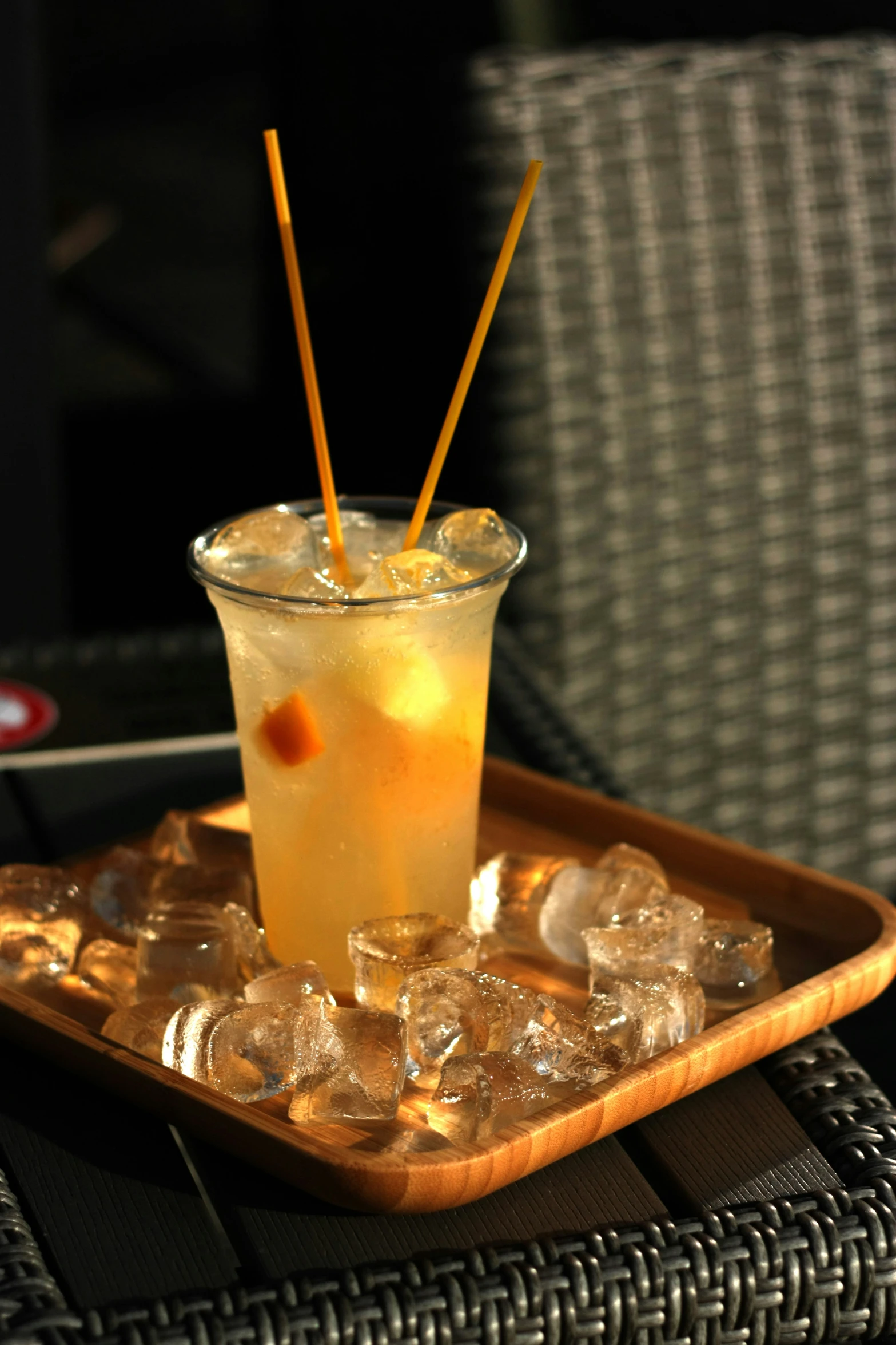 beverage served with yellow straws in brown tray