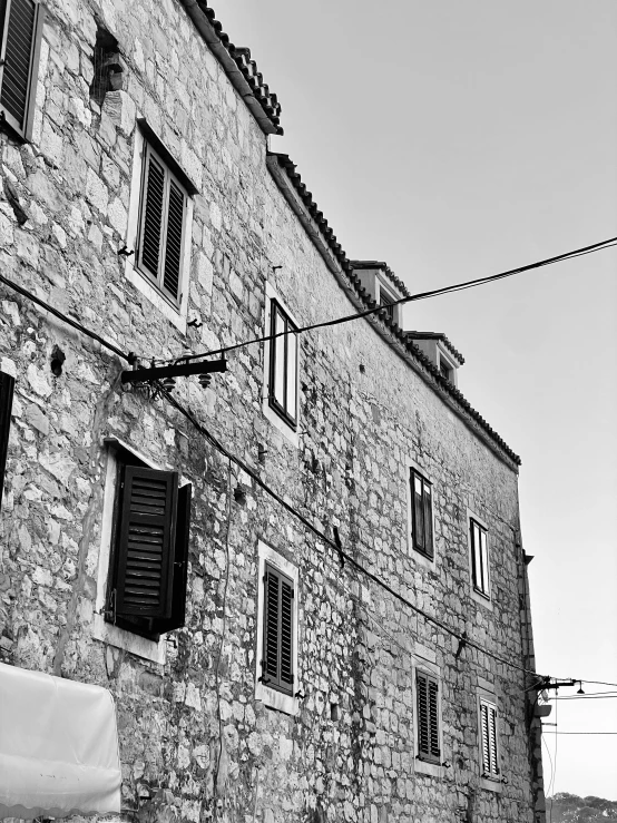 this stone building has two windows on one side