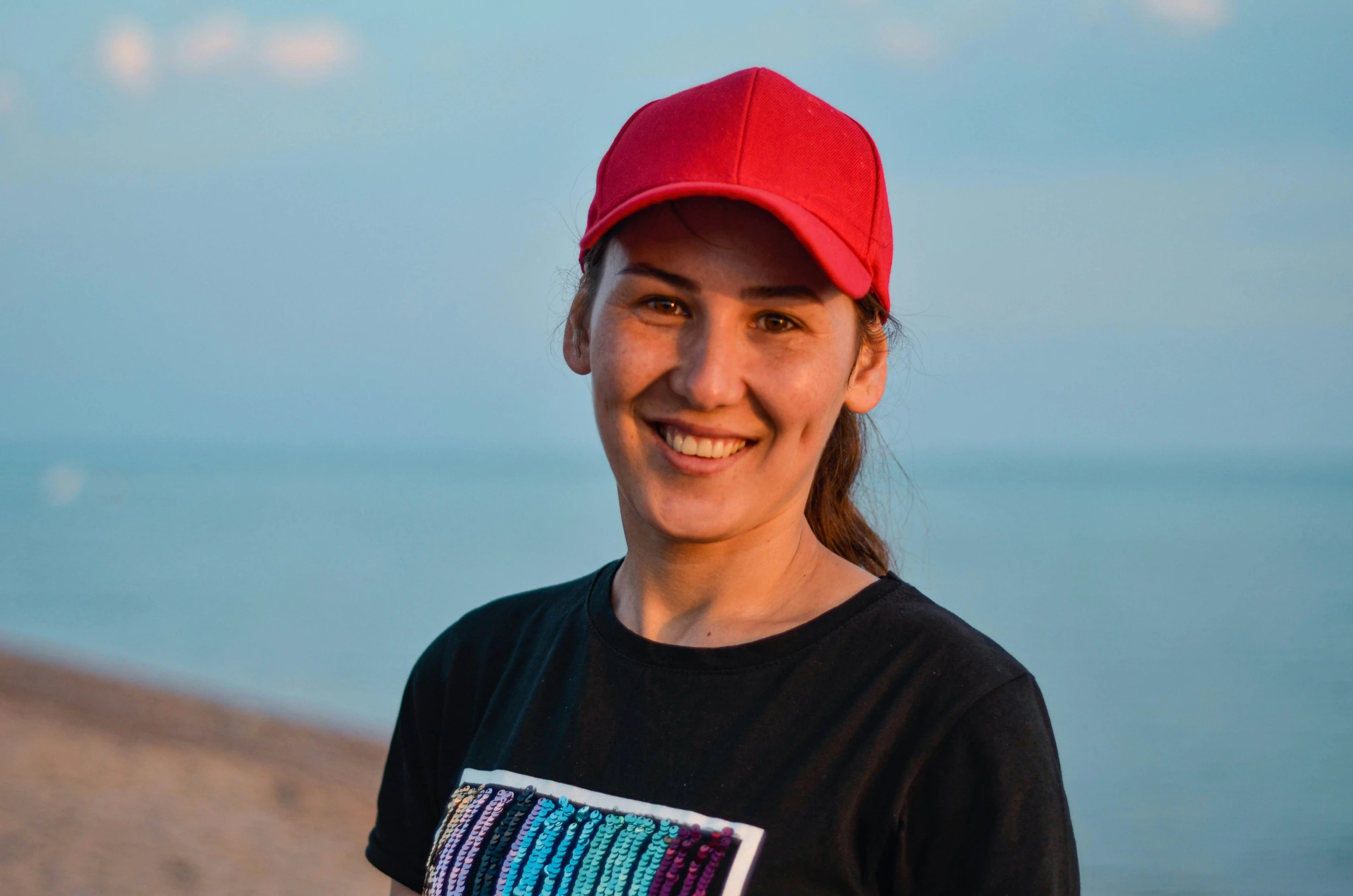 a woman is standing in front of the water