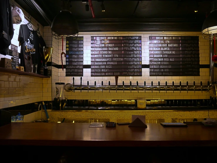 a bar with a few bottles and a menu behind the wall